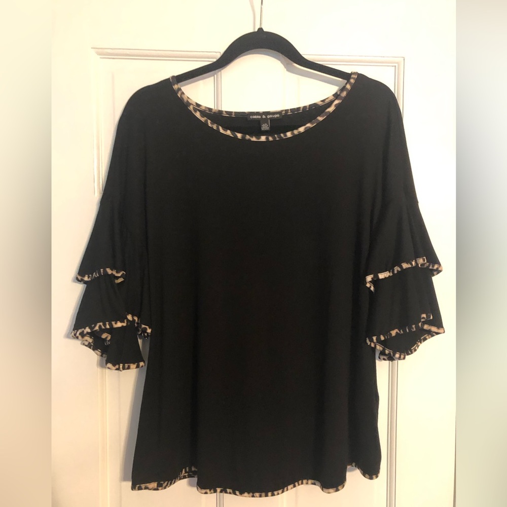 Black knit top with bell sleeves and leopard print trim